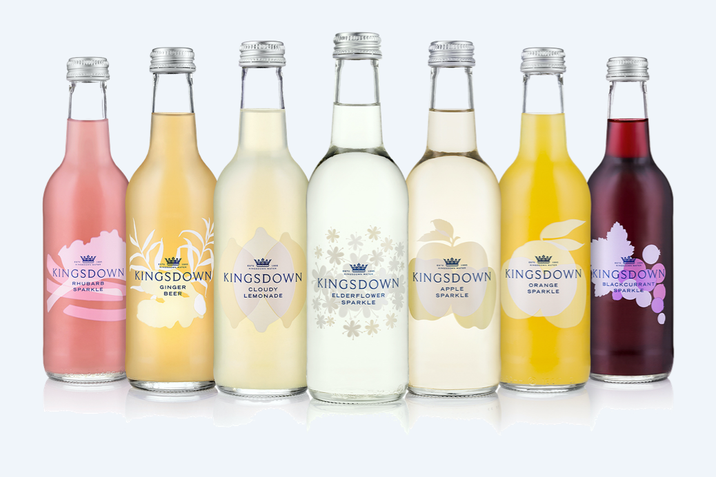 Seven bottles of Kingsdown Water drinks in front of a light blue background.