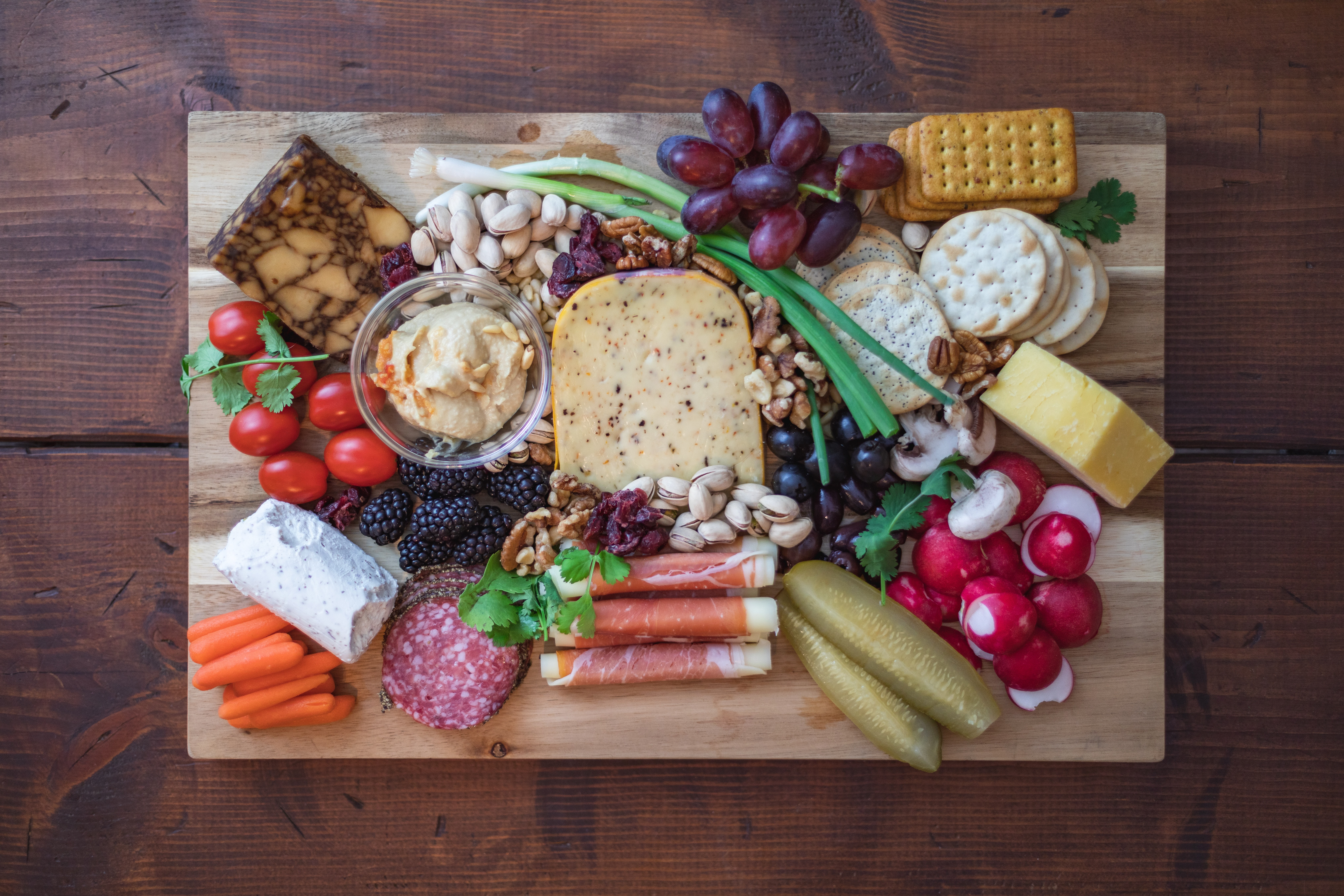 A selection of healthy snacks, including fruit, nuts and cheese.