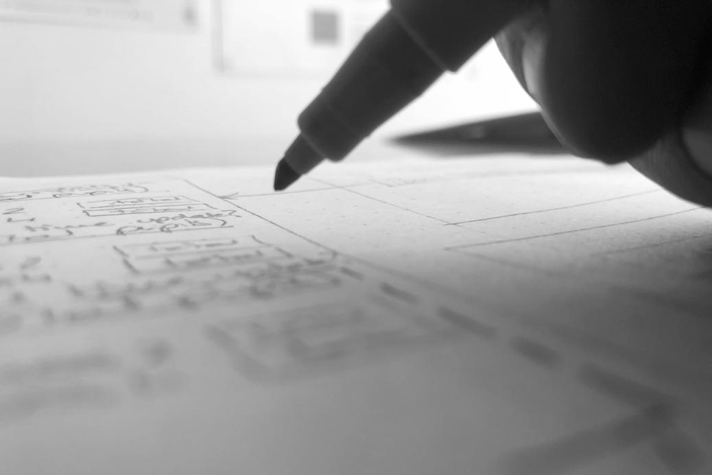 A black and white image of a broad tip pen being used to sketch ideas.