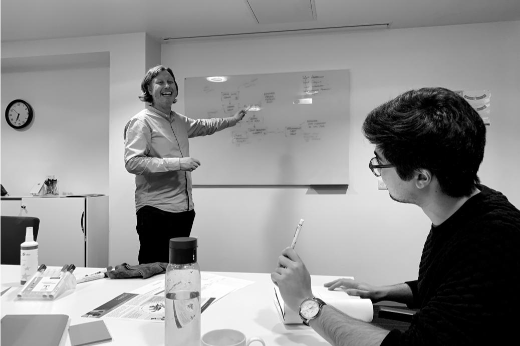Two people take part in a workshop to understand the user journeys through the app.