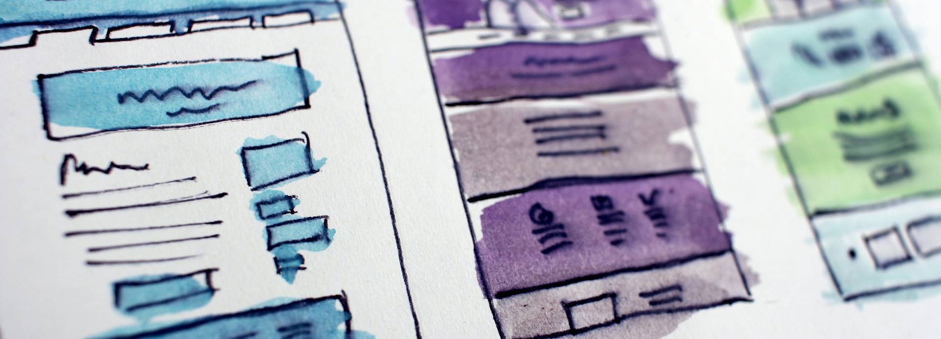 Three different pen-drawn wireframes show various digital page layouts. Each has had watercolour applied to add detail